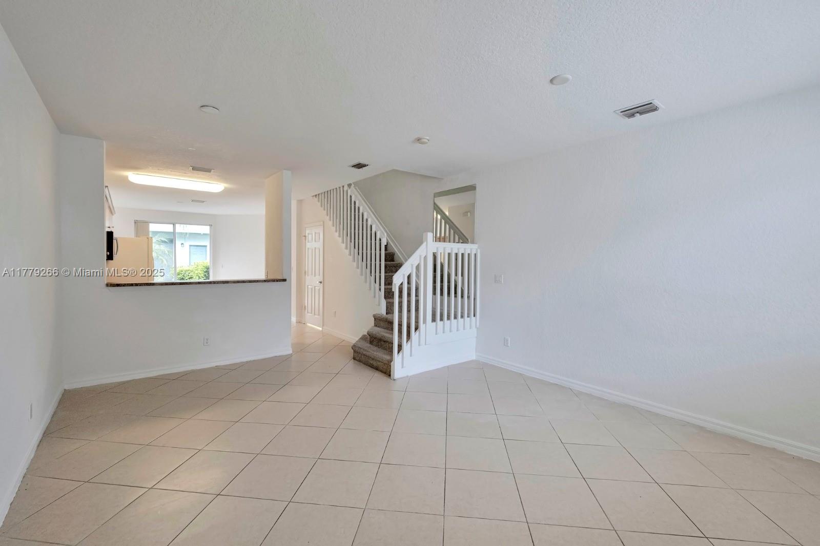 1925 Gardenia Court, Unit 1925 Riviera Beach, FL 33404 - Photo 8 of 10 a view of an empty room with a window