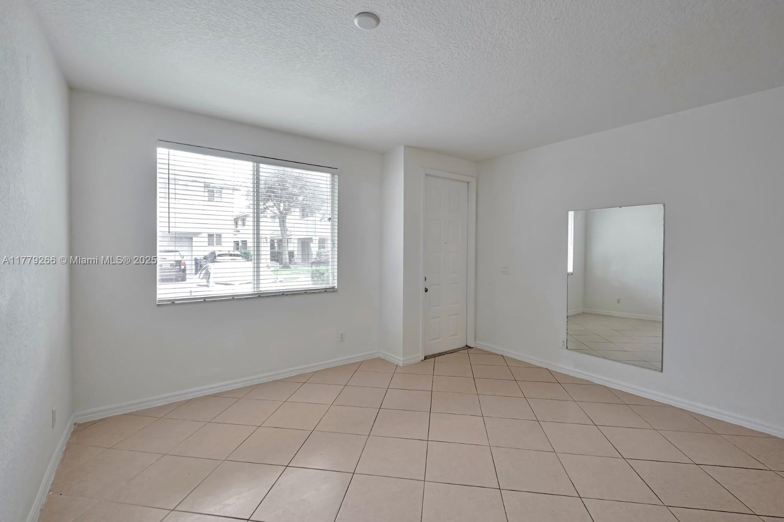 1925 Gardenia Court, Unit 1925 Riviera Beach, FL 33404 - Photo 9 of 10 a view of an empty room with a window