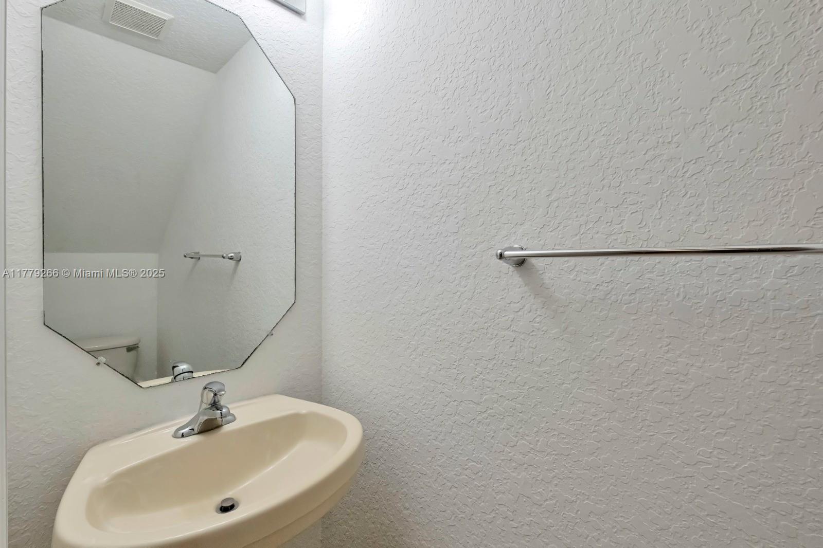 1925 Gardenia Court, Unit 1925 Riviera Beach, FL 33404 - Photo 10 of 10 a bathroom with a sink and a mirror
