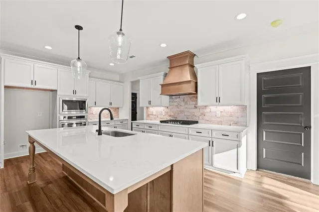 a kitchen with kitchen island a stove a sink and a refrigerator