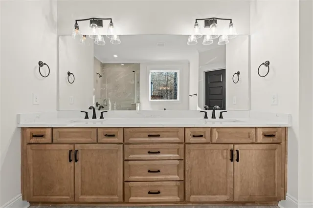 a bathroom with a sink vanity and mirror