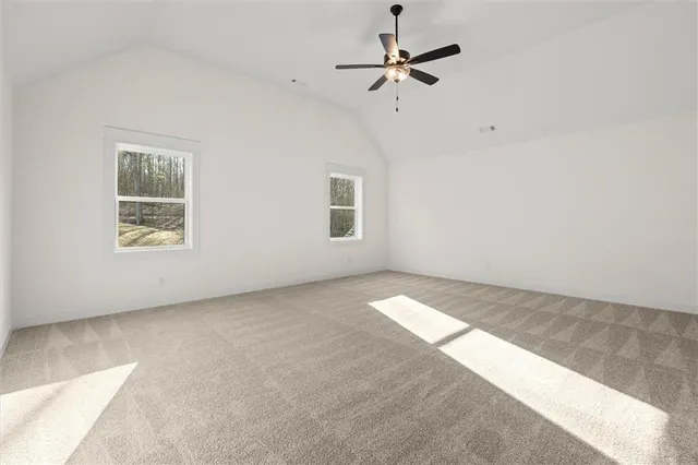 an empty room with a ceiling fan and a window