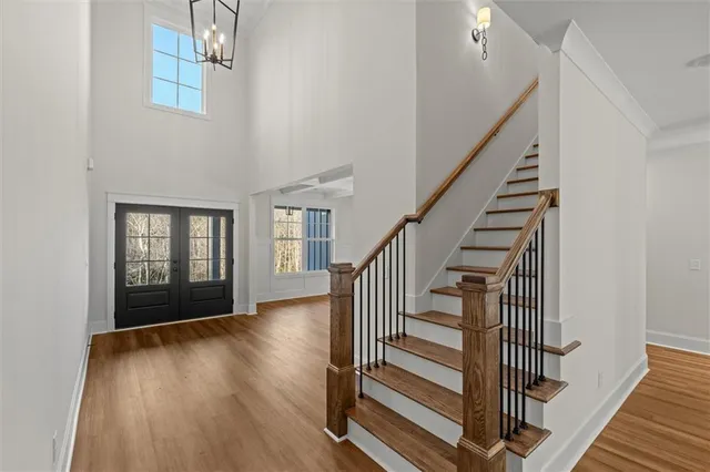 a view of staircase with wooden floor and white walls