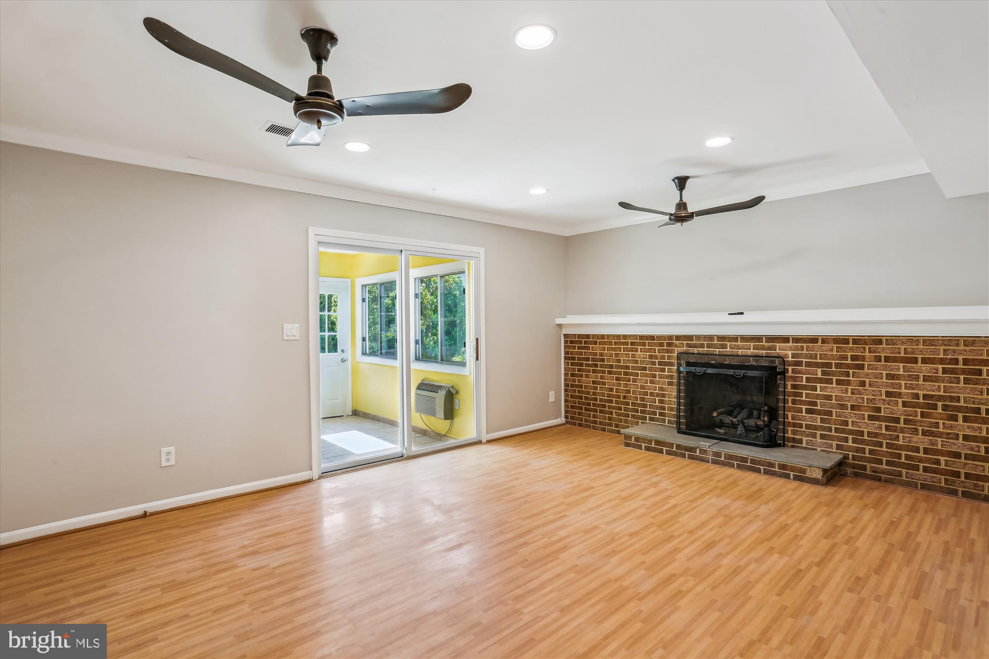 19916 Westerly Avenue Poolesville, MD 20837 - Photo 11 of 34 wooden floor fireplace and windows in an empty room