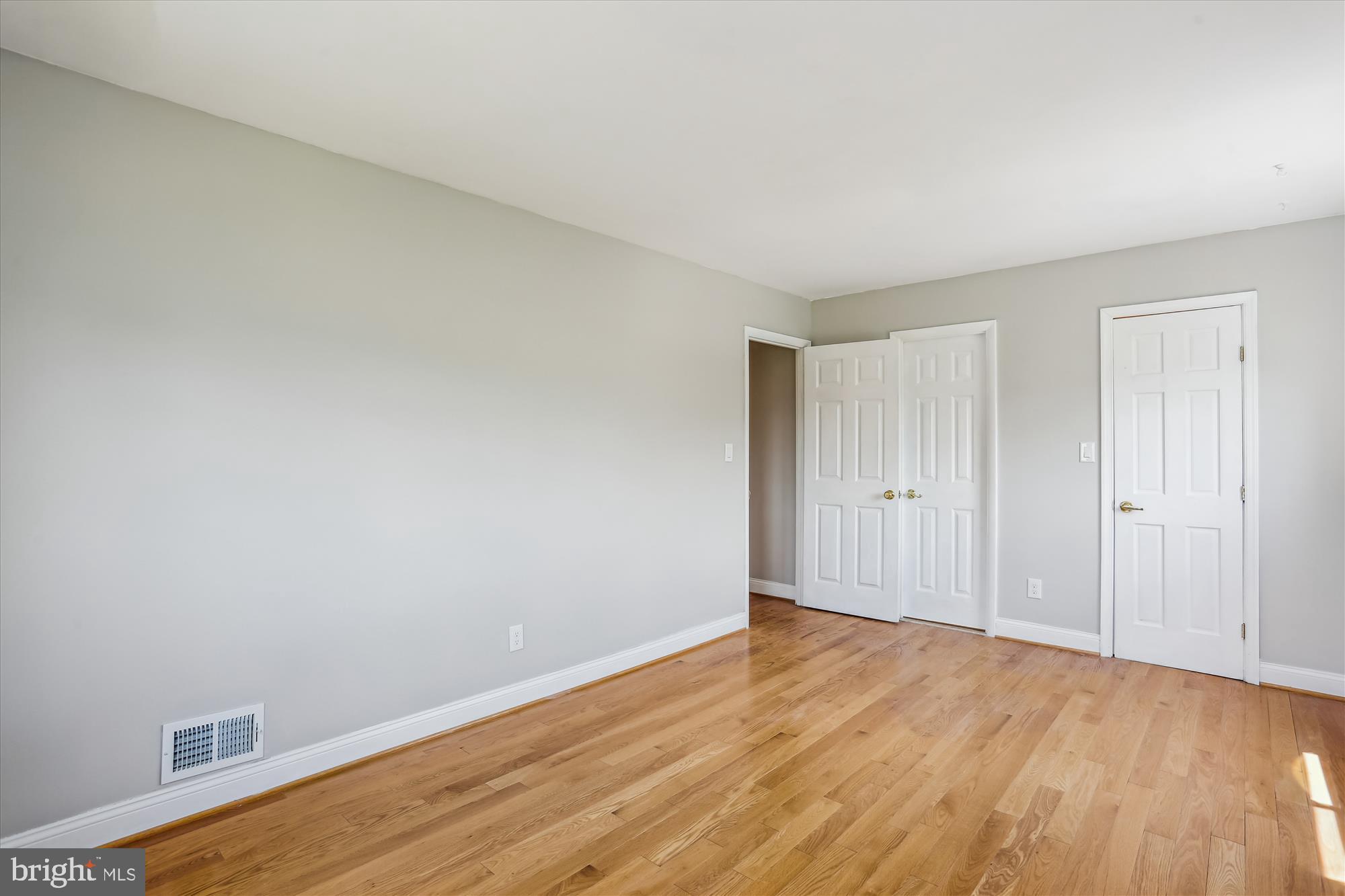 19916 Westerly Avenue Poolesville, MD 20837 - Photo 14 of 34 a view of an empty room with wooden floor