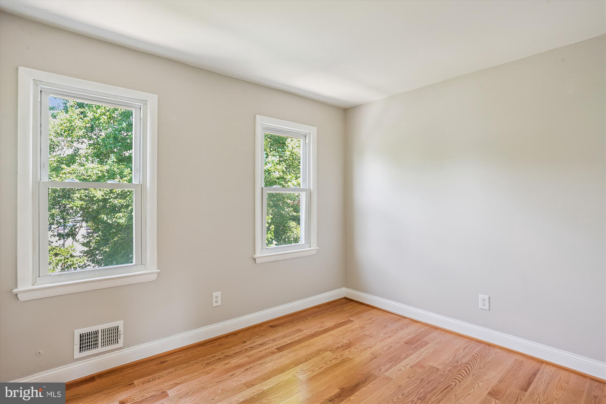19916 Westerly Avenue Poolesville, MD 20837 - Photo 19 of 34 a view of an empty room with wooden floor and a window