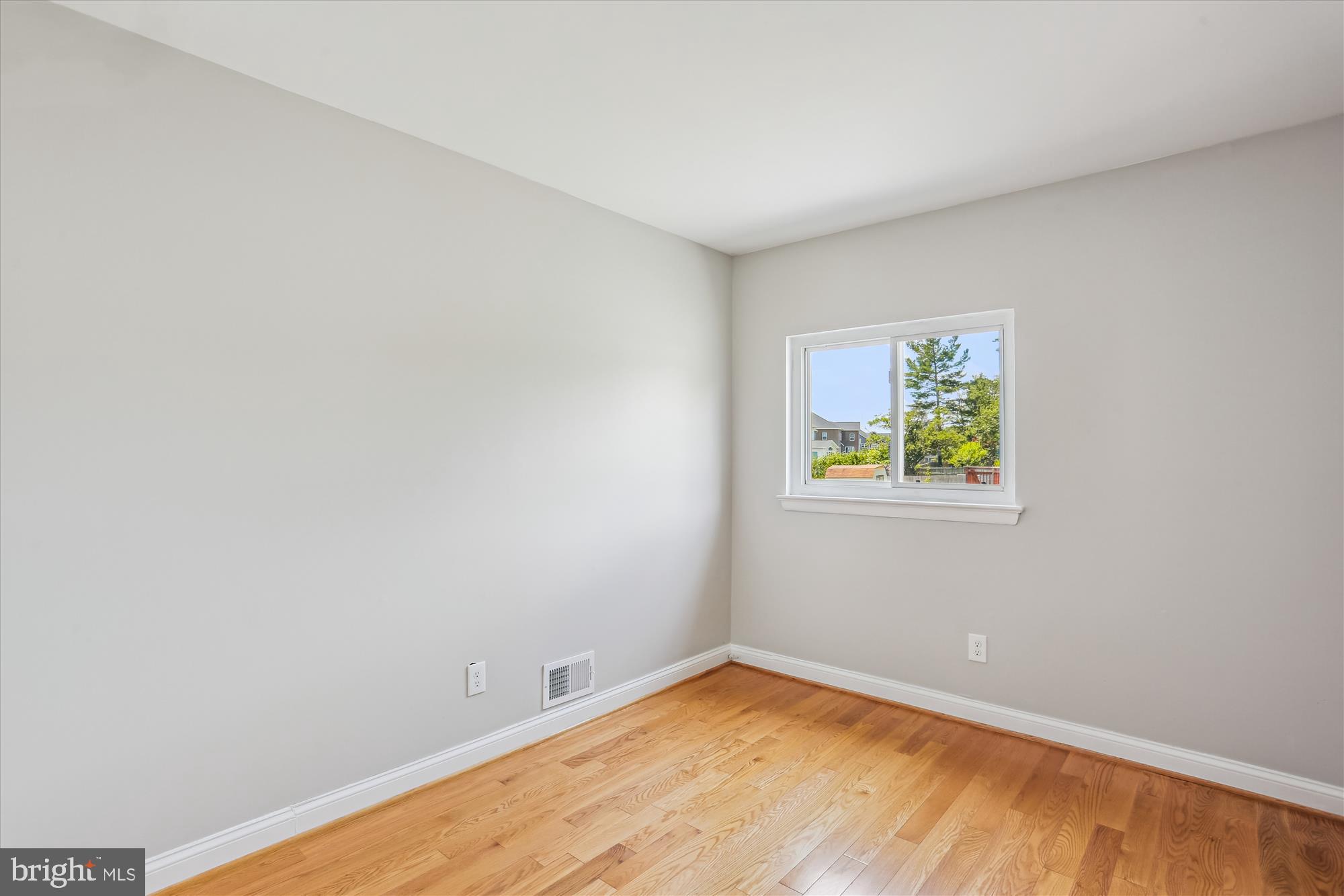 19916 Westerly Avenue Poolesville, MD 20837 - Photo 20 of 34 a view of an empty room with window and wooden floor