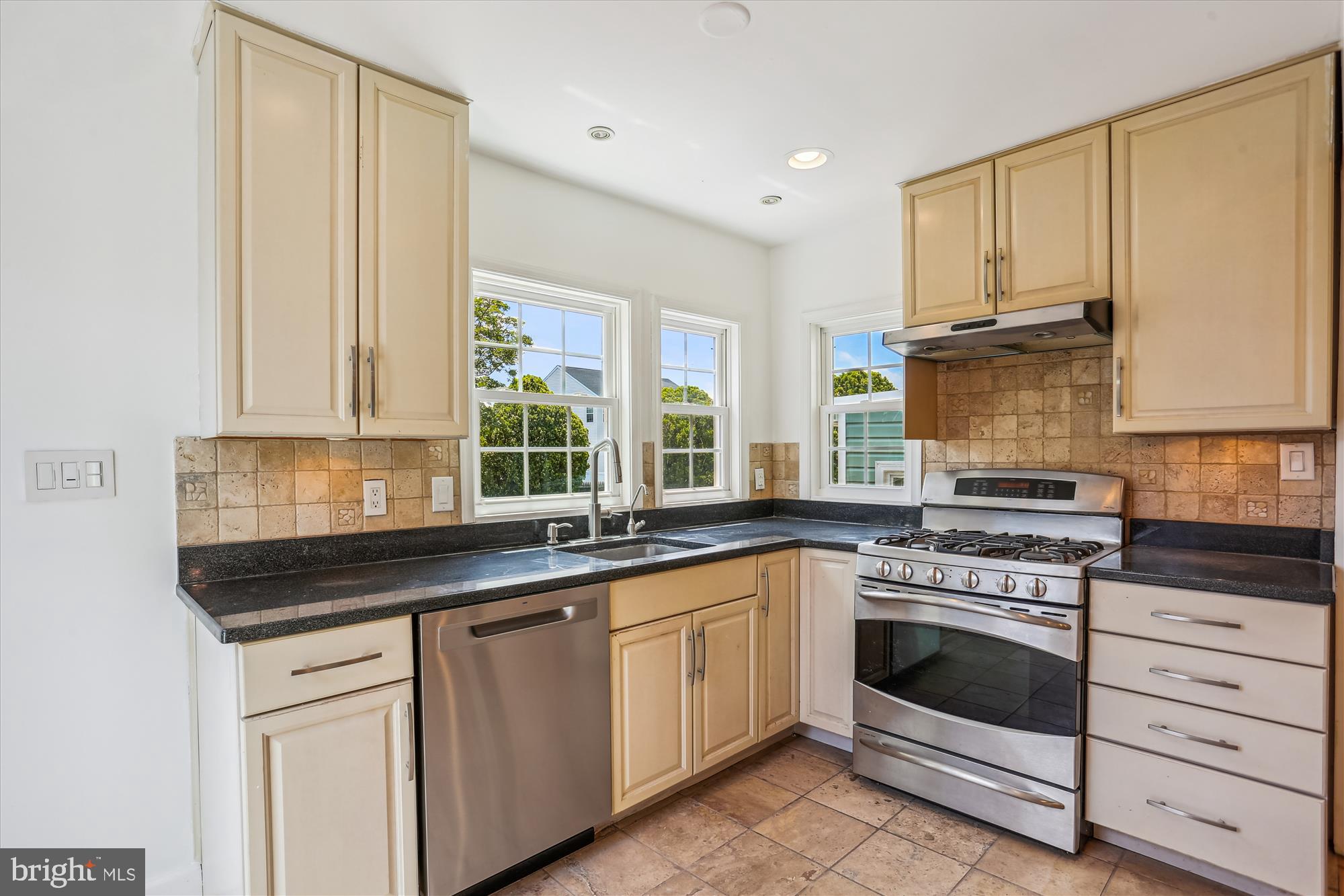 19916 Westerly Avenue Poolesville, MD 20837 - Photo 4 of 34 a kitchen with granite countertop white cabinets and white stainless steel appliances
