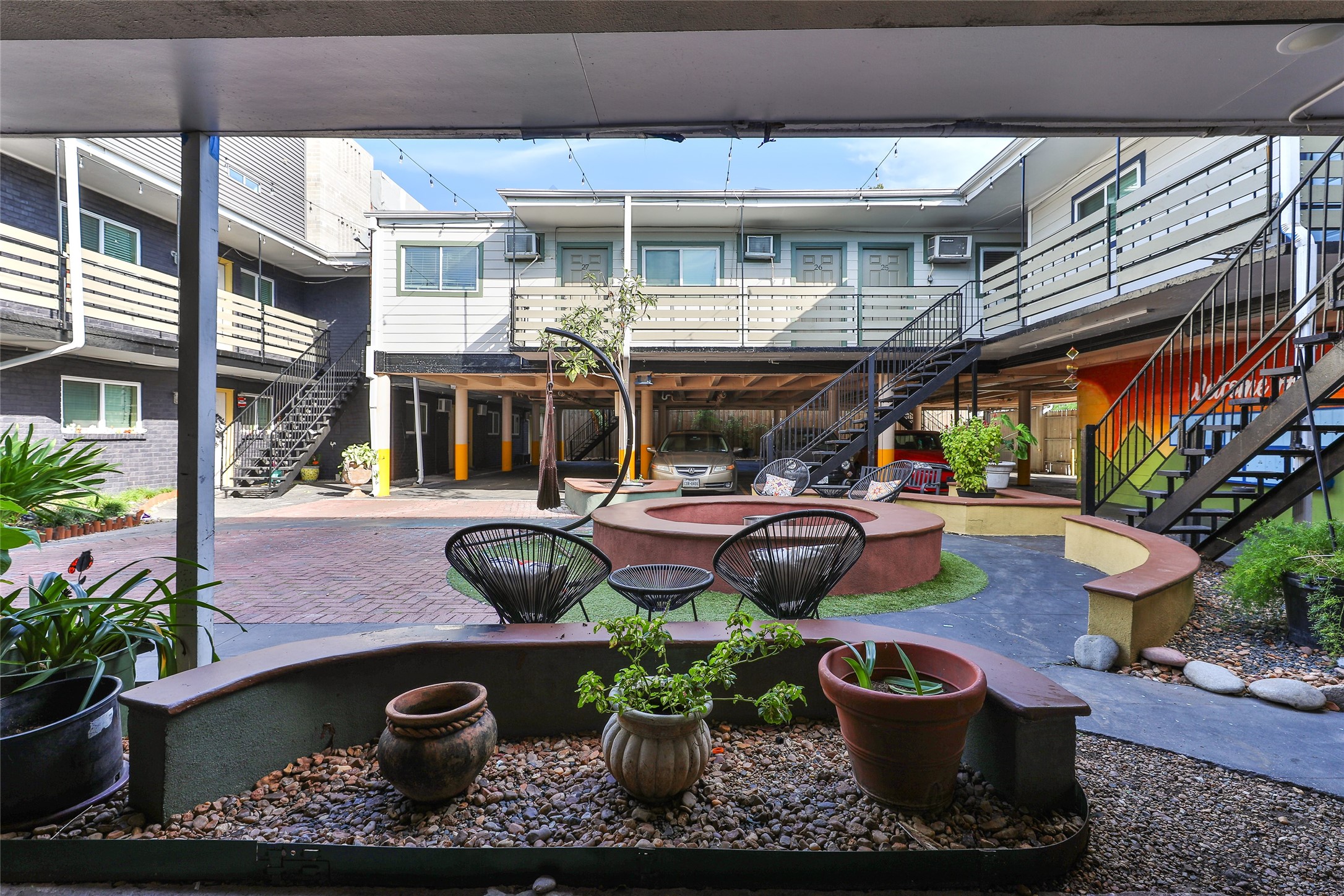 1840 Richmond Avenue, Unit 15 Houston, TX 77098 - Photo 4 of 14 a view of a patio with table and chairs potted plants