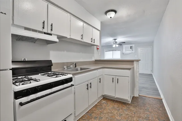 a kitchen with cabinets and appliances