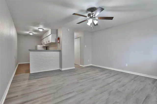 a view of a kitchen with a dishwasher cabinets and wooden floor