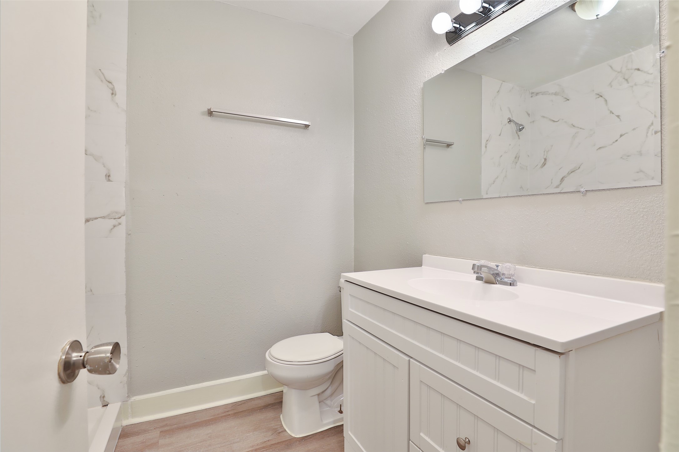 1840 Richmond Avenue, Unit 15 Houston, TX 77098 - Photo 10 of 14 a bathroom with a sink a toilet and a mirror