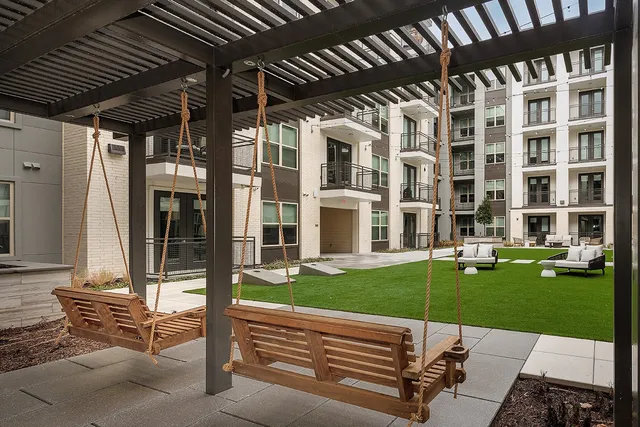 a living room with furniture a rug and a large window