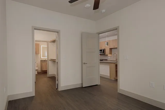 a view of a kitchen with a white cabinet and a stove top oven