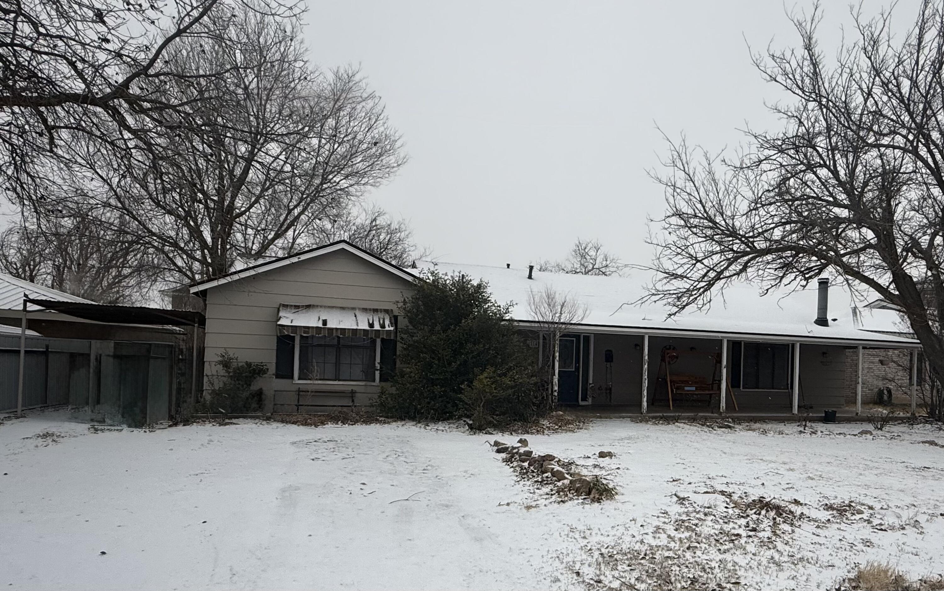 a front view of a house with a yard and a garage
