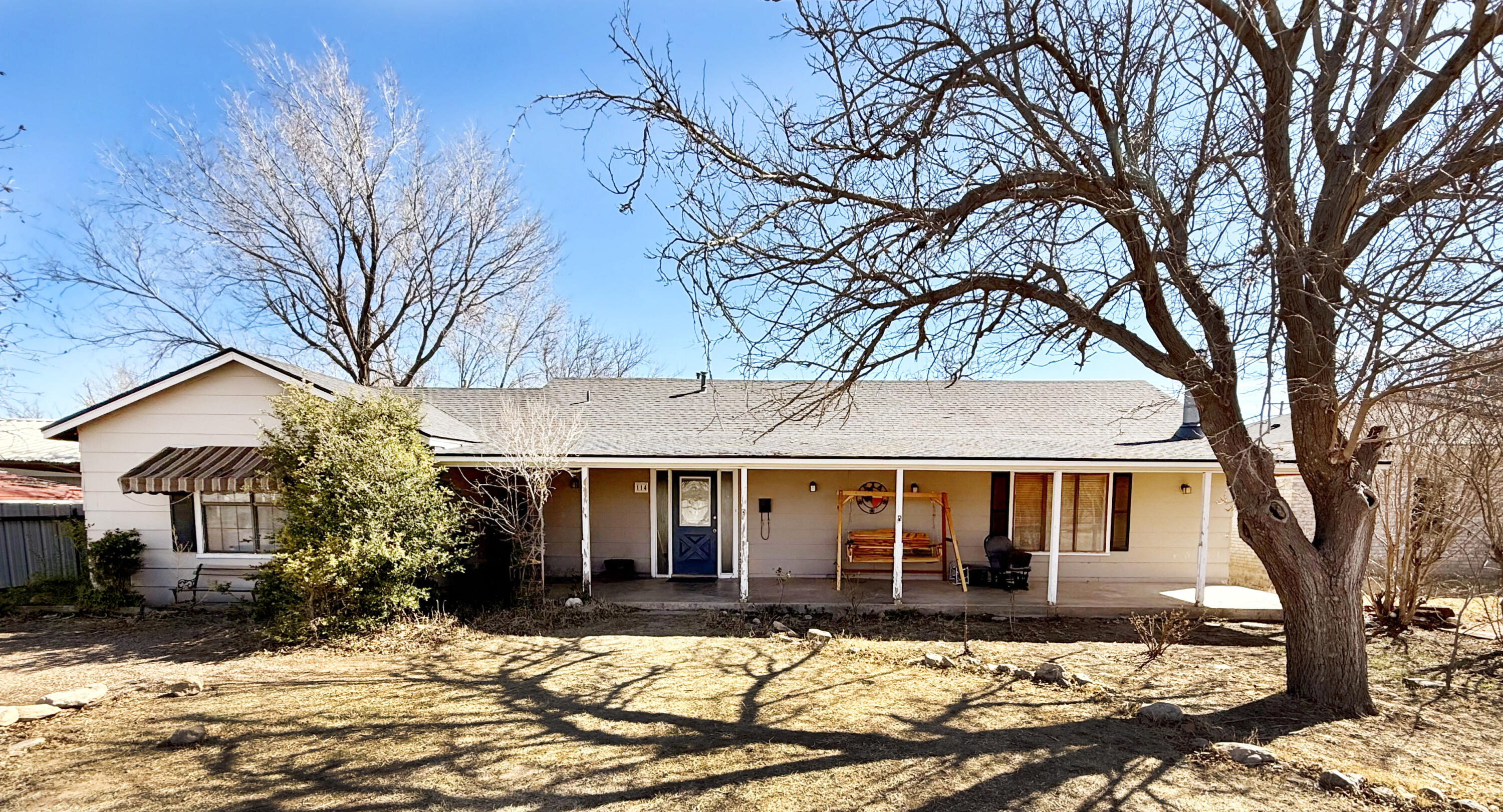 a front view of a house with a yard covered in snow