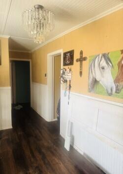 114 North Ave O Post, TX 79356 - Photo 11 of 43 a view of a hallway with wooden floor and a chandelier