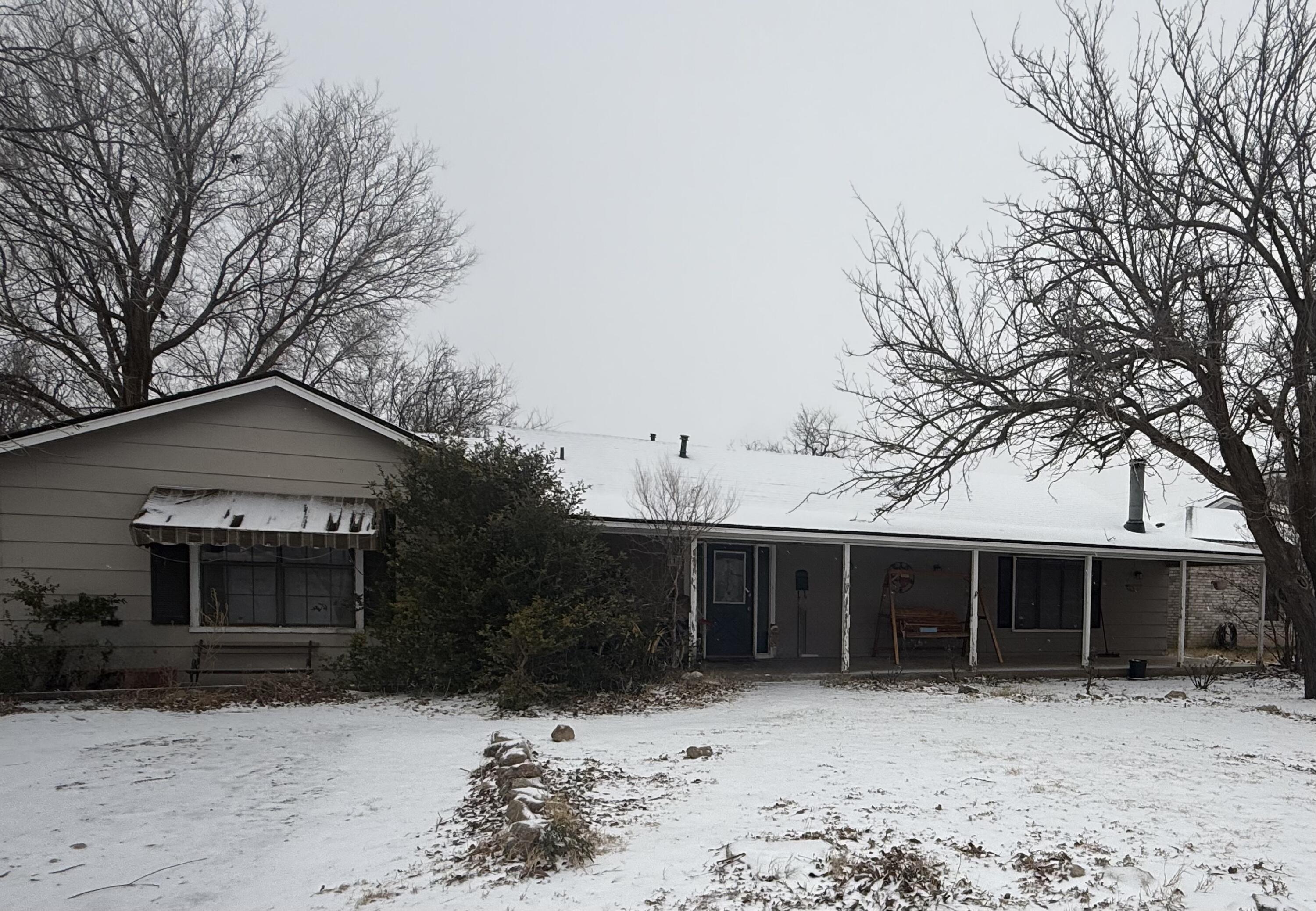 114 North Ave O Post, TX 79356 - Photo 2 of 43 a front view of a house with a yard covered with snow in front of house