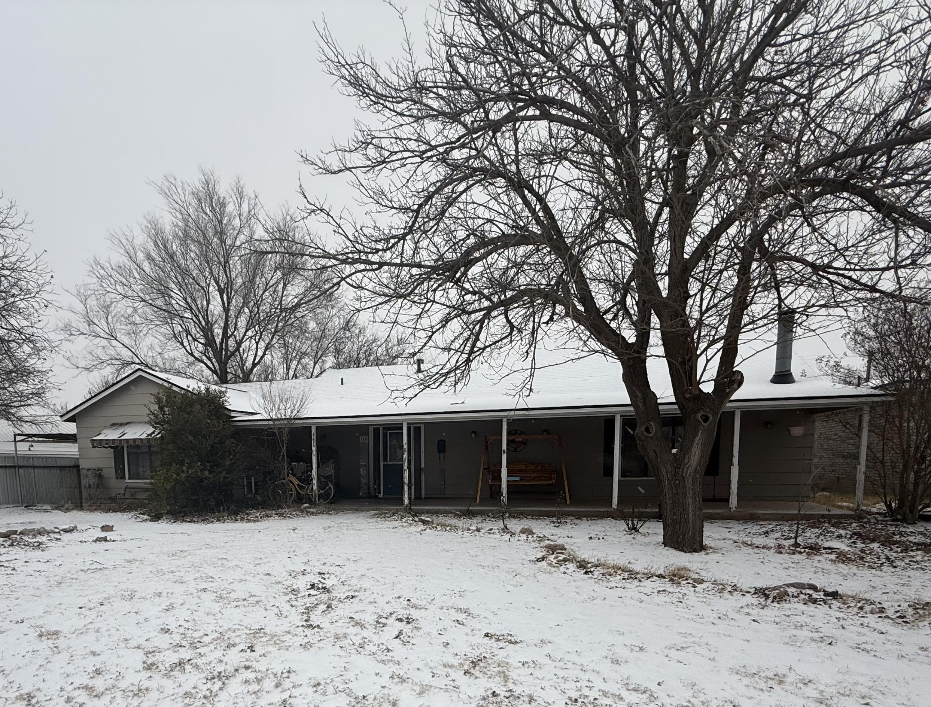 114 North Ave O Post, TX 79356 - Photo 3 of 43 a front view of a house with a yard covered in snow