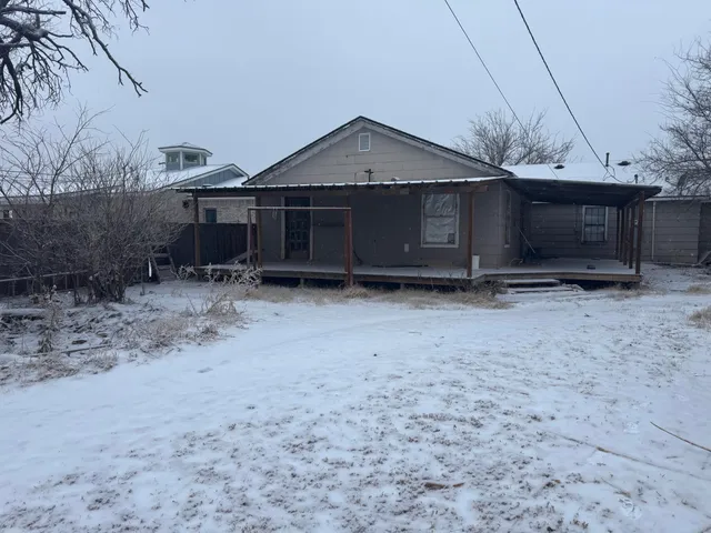 a view of a hallway with wooden floor and a chandelier