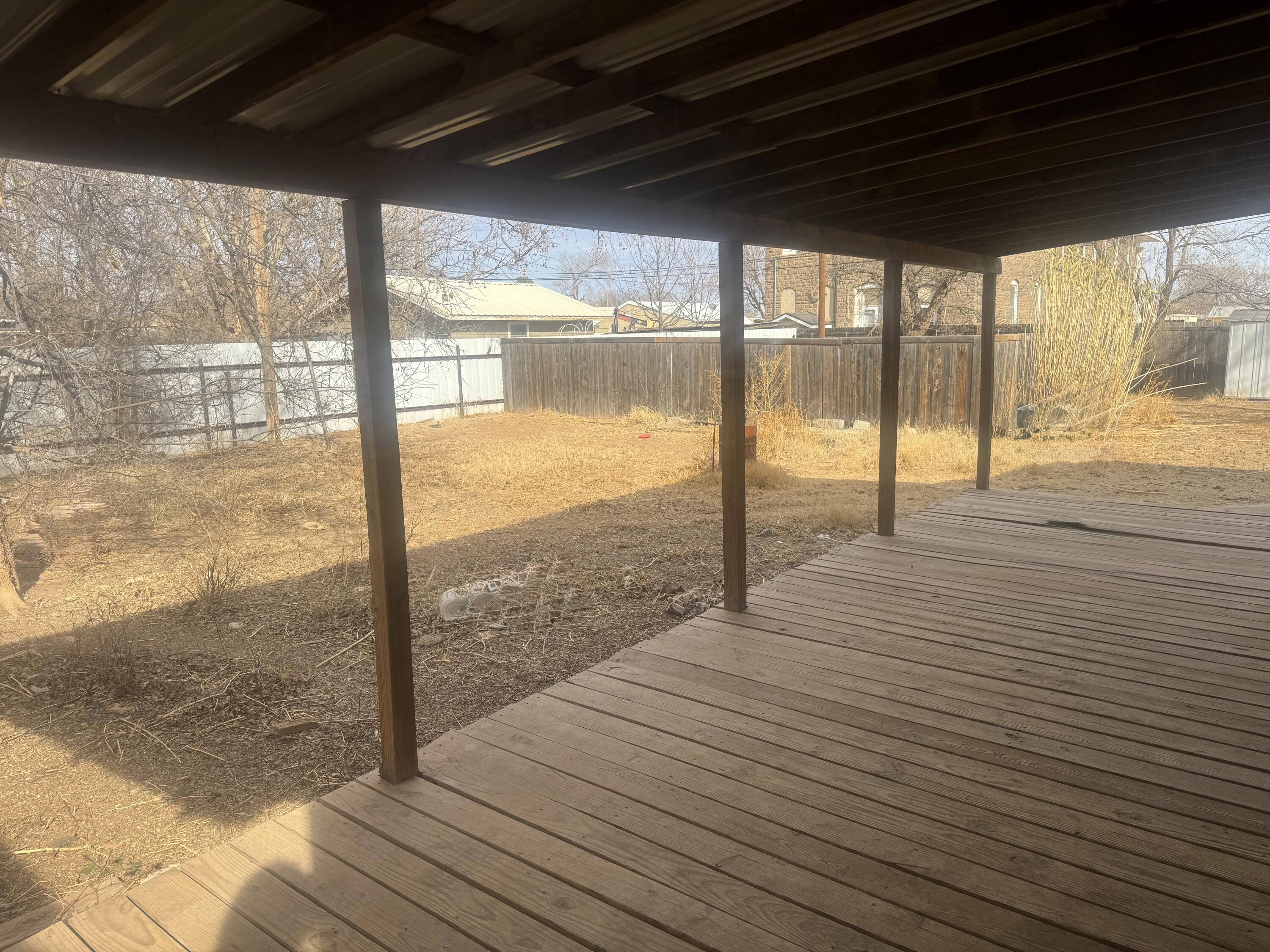 114 North Ave O Post, TX 79356 - Photo 43 of 43 a view of an empty room with wooden floor and a floor to ceiling window