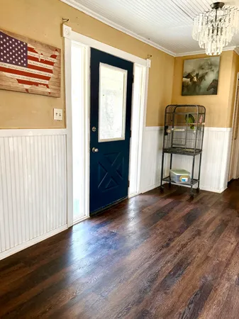 a living room with furniture and a chandelier