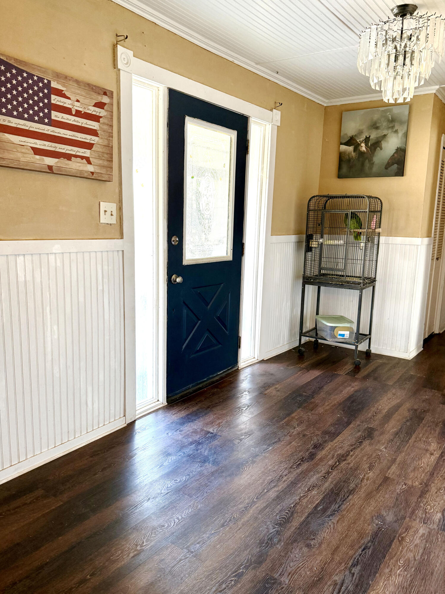 114 North Ave O Post, TX 79356 - Photo 7 of 39 a view of a hallway to room with wooden floor and furniture