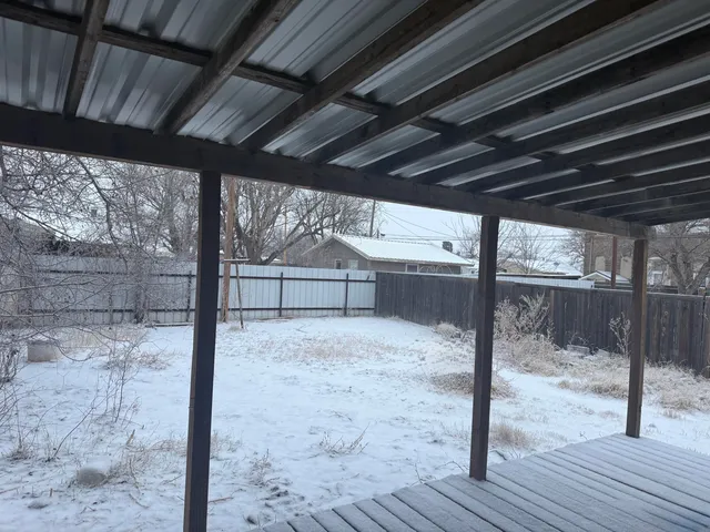 a view of a bedroom with wooden floor