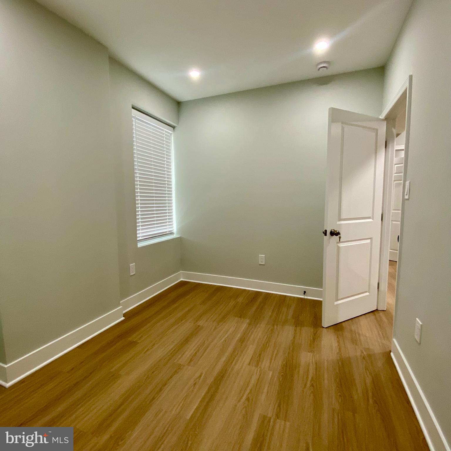 3701 9th Street Northwest, Unit 1 Washington, DC 20010 - Photo 14 of 23 an empty room with wooden floor and white walls