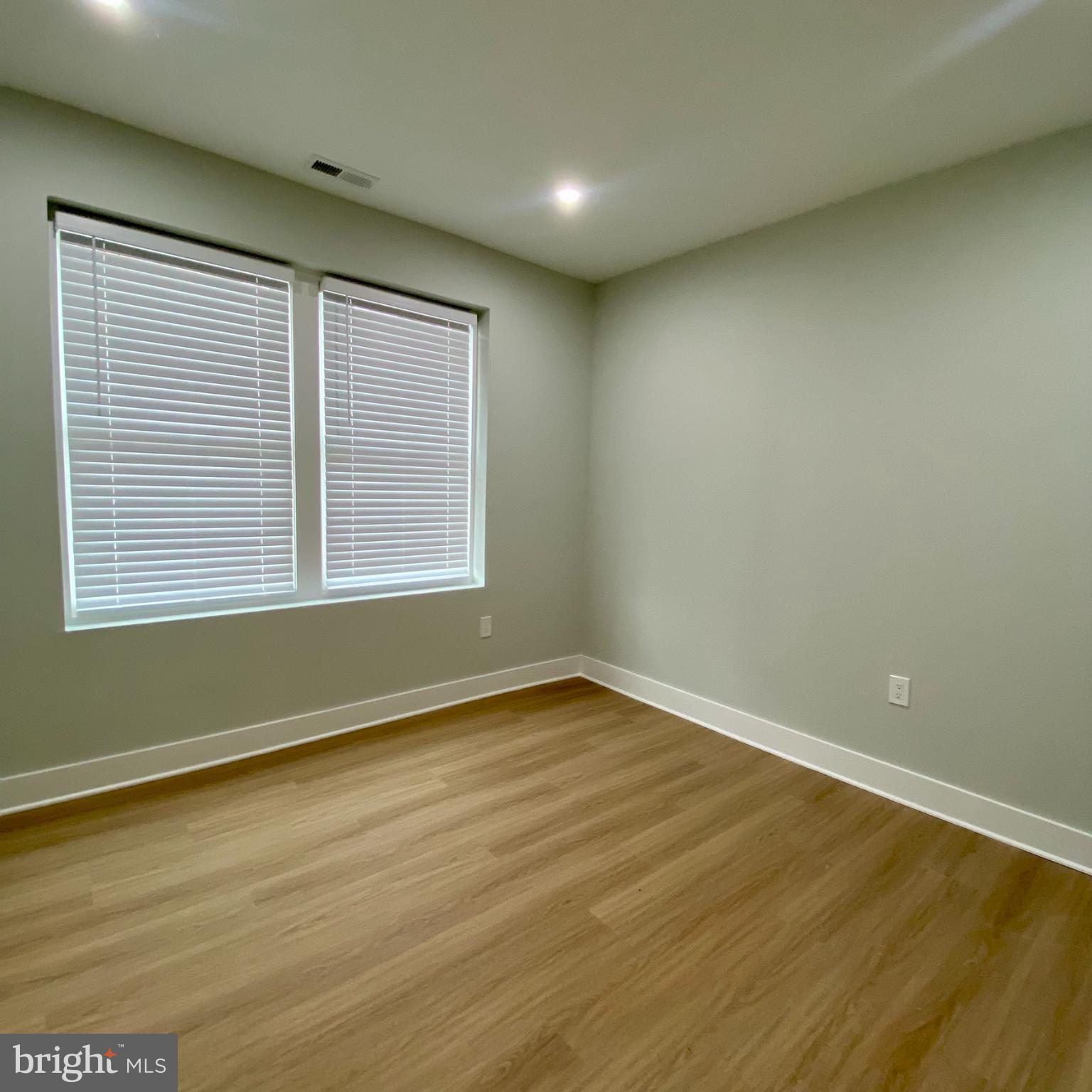 3701 9th Street Northwest, Unit 1 Washington, DC 20010 - Photo 16 of 23 an empty room with wooden floor and windows