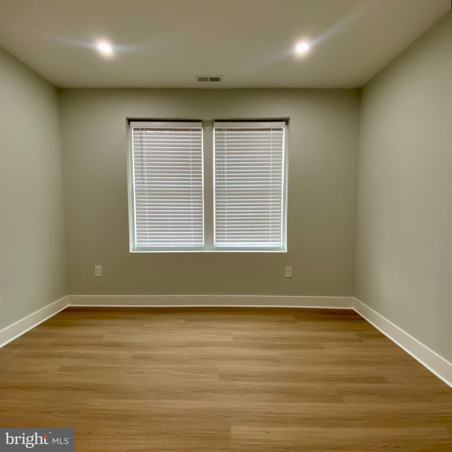3701 9th Street Northwest, Unit 1 Washington, DC 20010 - Photo 17 of 23 an empty room with wooden floor and windows