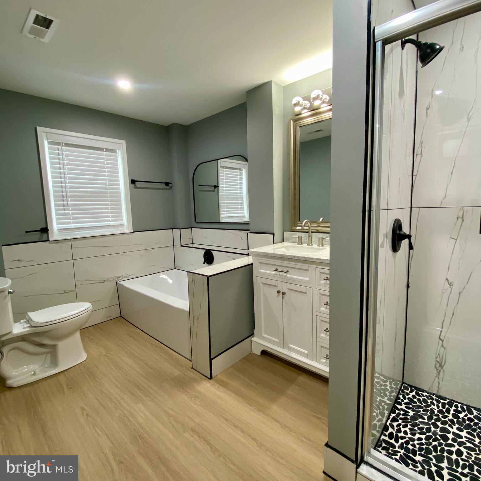 3701 9th Street Northwest, Unit 1 Washington, DC 20010 - Photo 19 of 23 a bathroom with a sink a toilet and shower