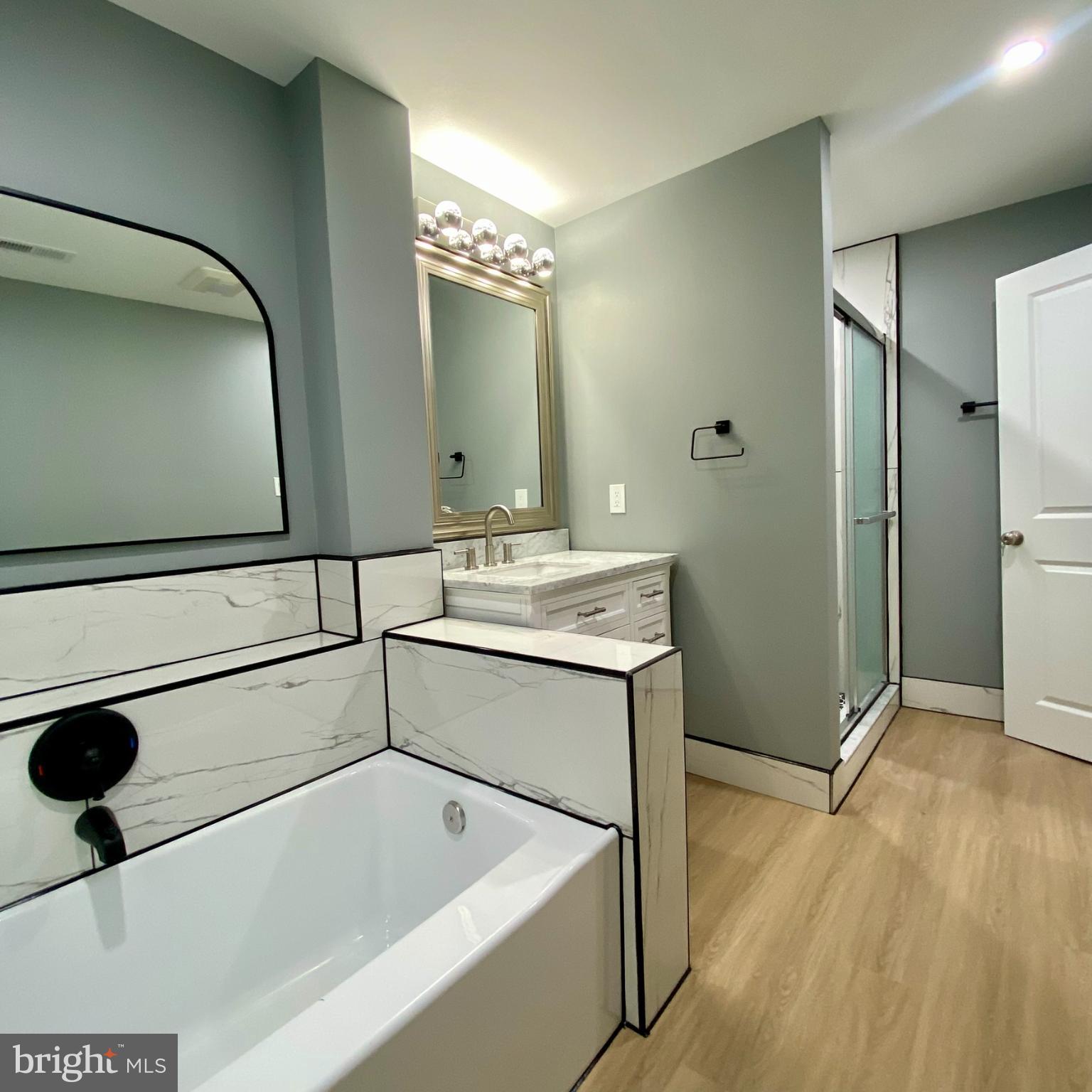 3701 9th Street Northwest, Unit 1 Washington, DC 20010 - Photo 20 of 23 a bathroom with a tub sink and mirror