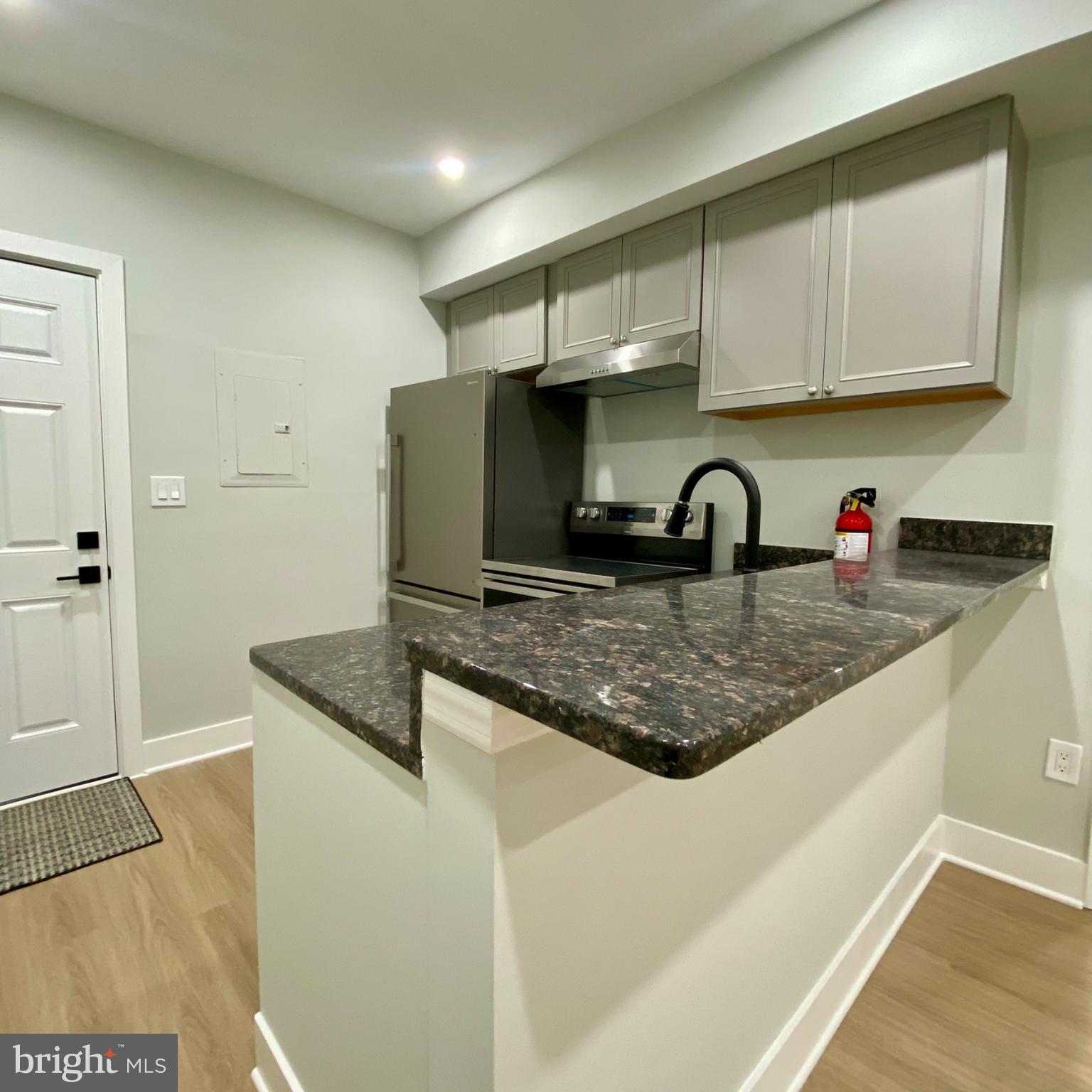 3701 9th Street Northwest, Unit 1 Washington, DC 20010 - Photo 2 of 23 a kitchen with cabinets and window