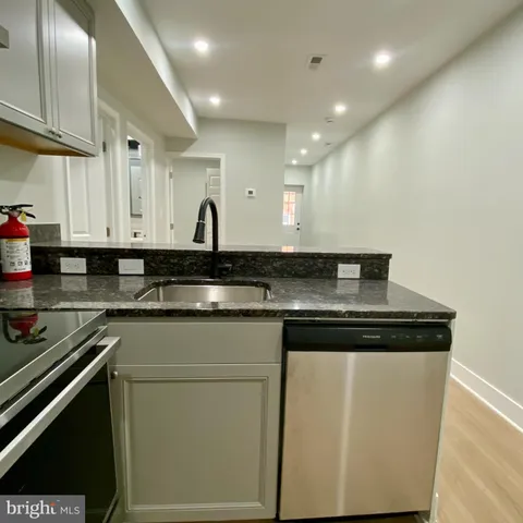 a kitchen with stainless steel appliances granite countertop a sink and cabinets
