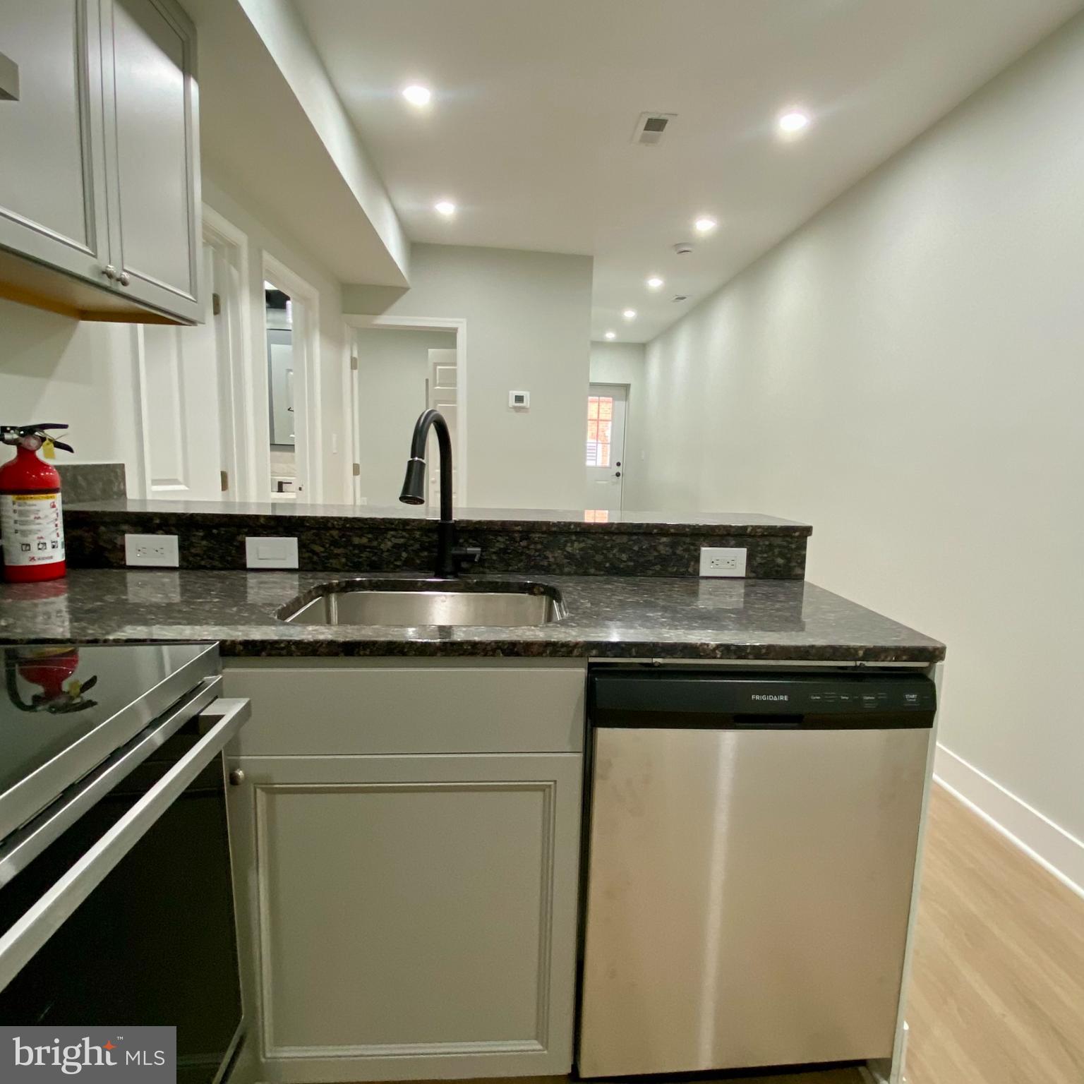 3701 9th Street Northwest, Unit 1 Washington, DC 20010 - Photo 4 of 23 a kitchen with stainless steel appliances granite countertop a sink and cabinets