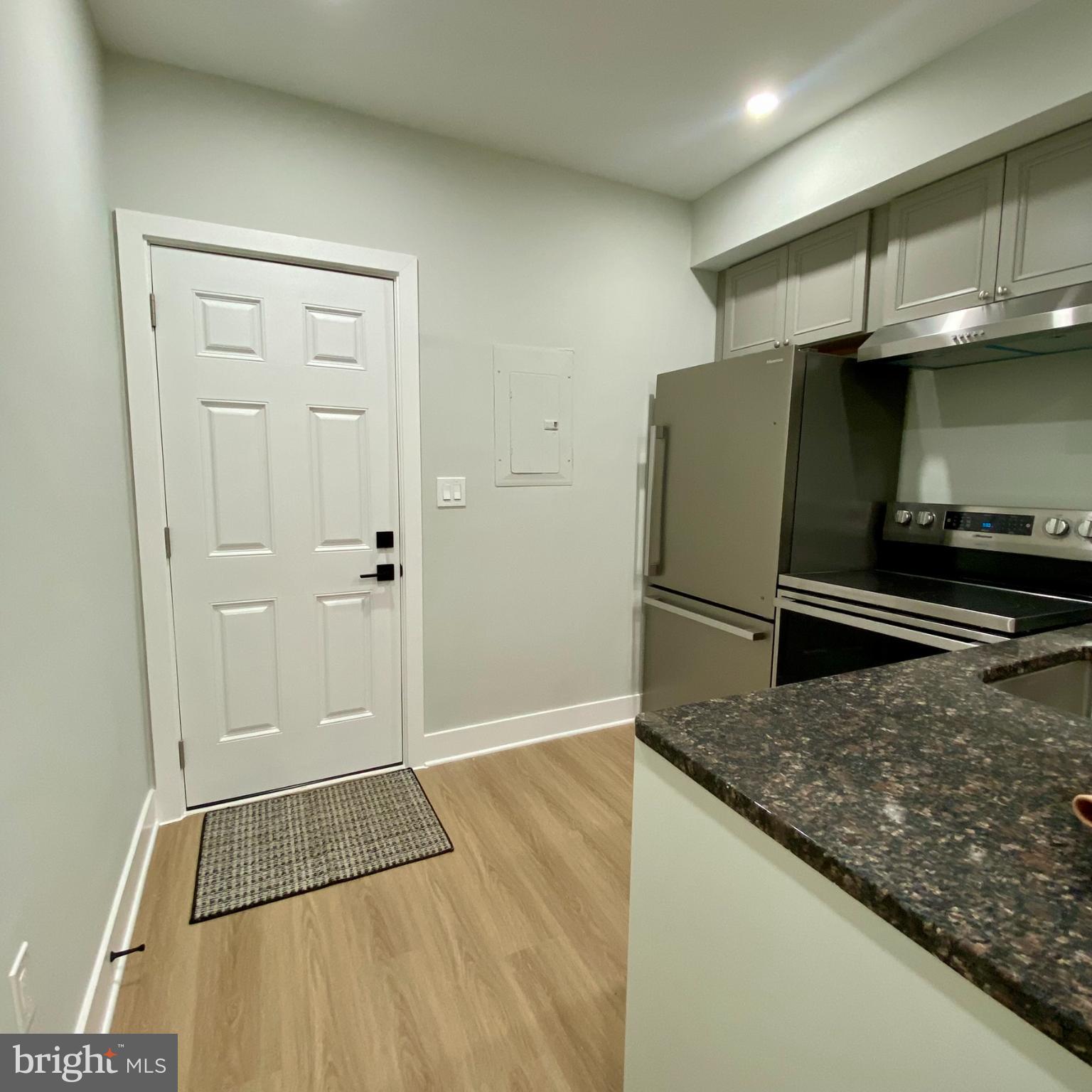 3701 9th Street Northwest, Unit 1 Washington, DC 20010 - Photo 5 of 23 a kitchen with granite countertop a refrigerator and a sink