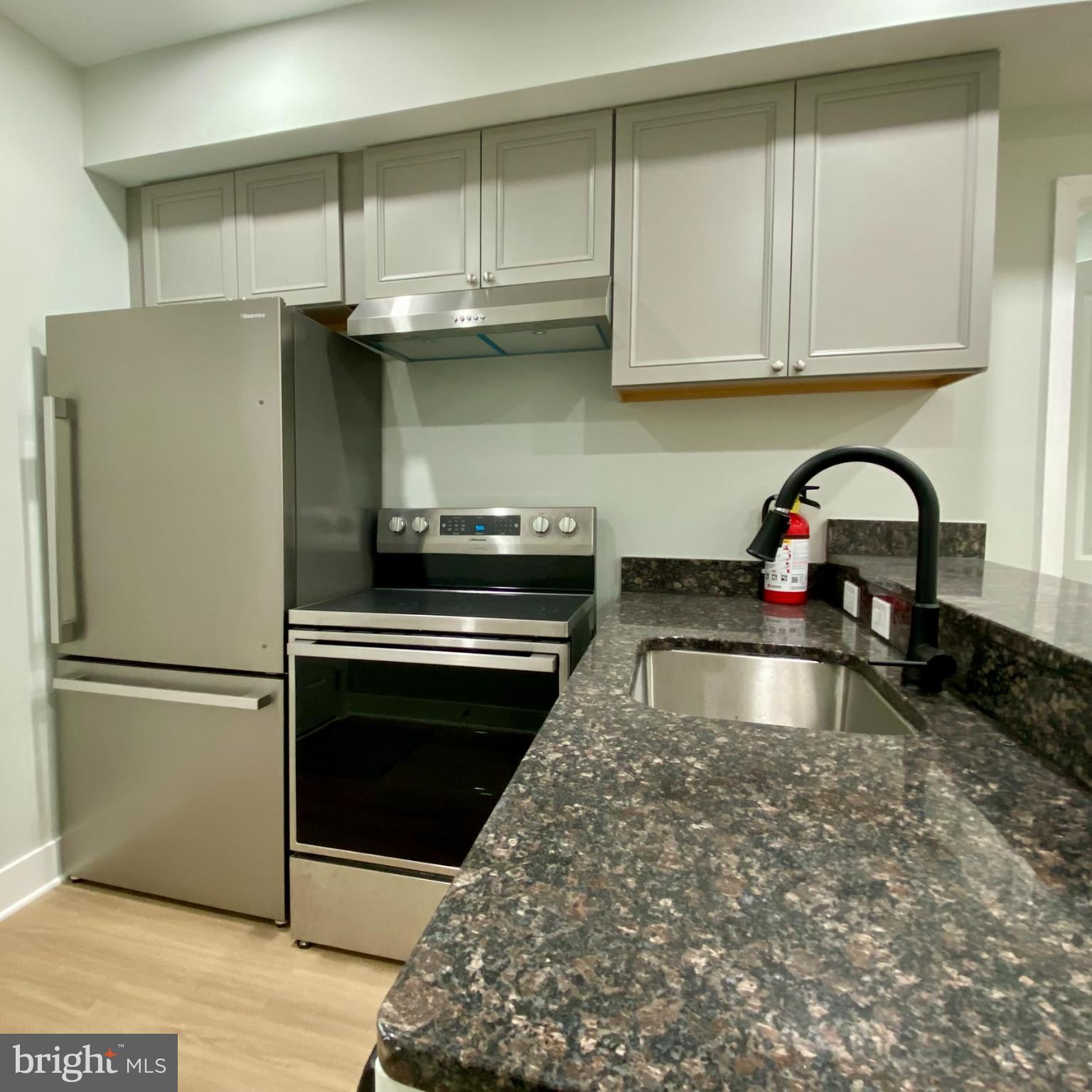 3701 9th Street Northwest, Unit 1 Washington, DC 20010 - Photo 6 of 23 a kitchen with granite countertop a refrigerator and a sink