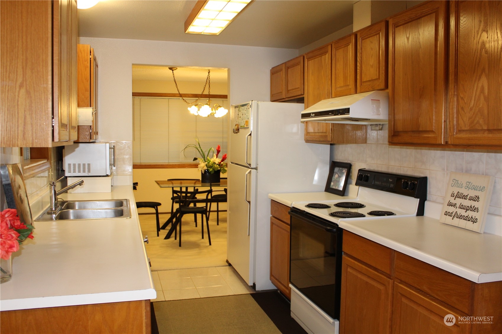2519 Northeast 145th Street Seattle, WA 98125 - Photo 13 of 34 a kitchen with stainless steel appliances a stove a sink refrigerator and cabinets