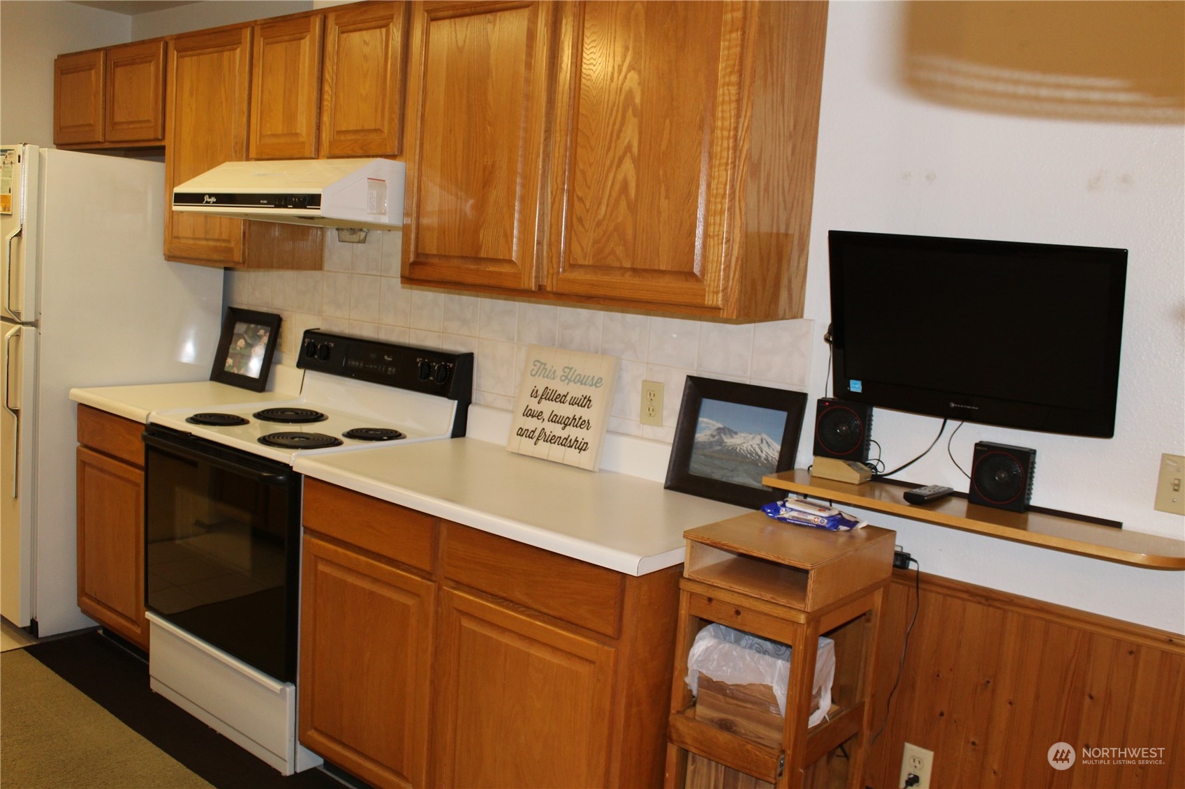 2519 Northeast 145th Street Seattle, WA 98125 - Photo 14 of 34 a kitchen with stainless steel appliances a stove microwave and refrigerator