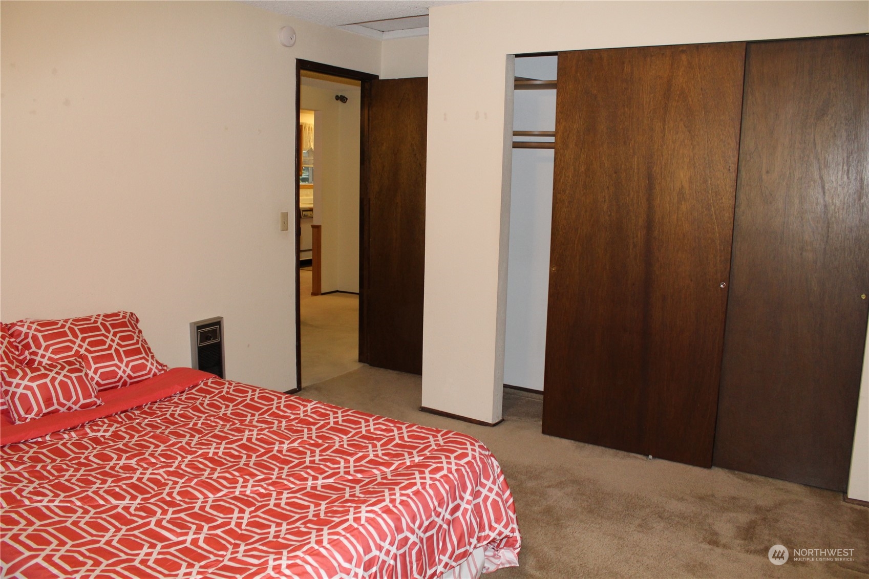 2519 Northeast 145th Street Seattle, WA 98125 - Photo 19 of 34 a bedroom with a bed and a mirror