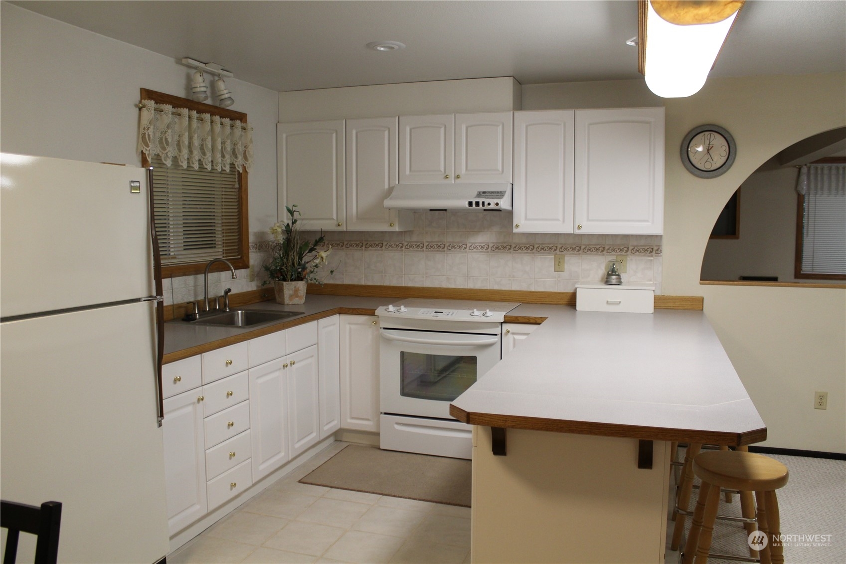 2519 Northeast 145th Street Seattle, WA 98125 - Photo 21 of 34 a kitchen with granite countertop a sink stove and refrigerator