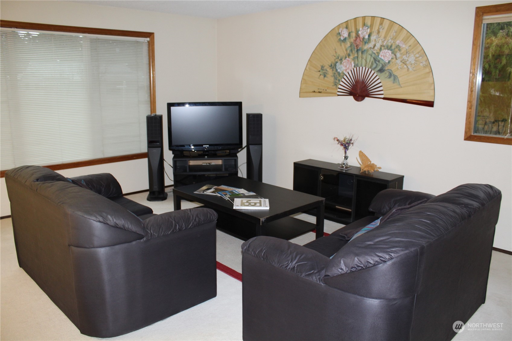 2519 Northeast 145th Street Seattle, WA 98125 - Photo 8 of 34 a living room with couches and a flat screen tv