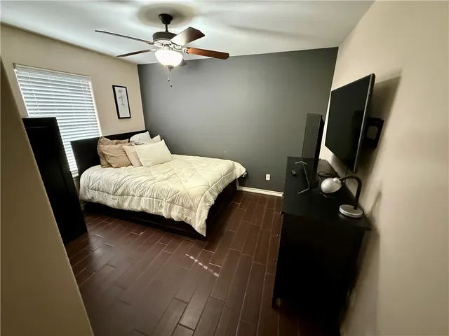 a bedroom with a bed dresser and a window