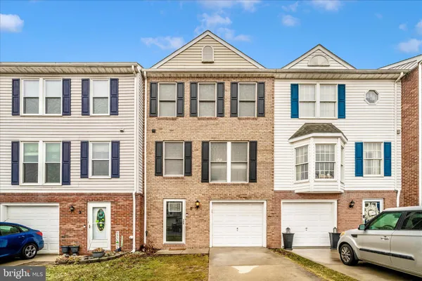 a front view of a residential apartment building with a yard