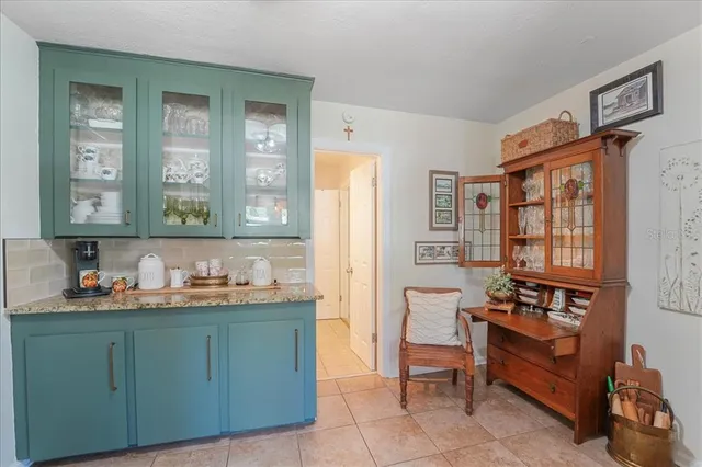 a kitchen with a refrigerator and a stove