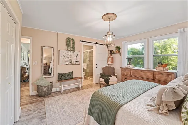 a bedroom with a bed couch and a window