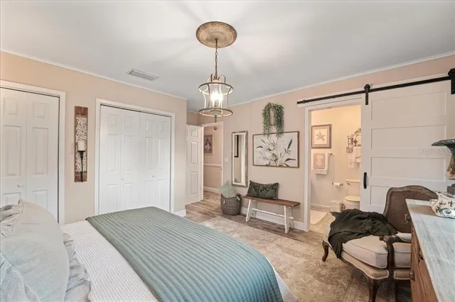 a bathroom with a toilet a sink a mirror and a shower