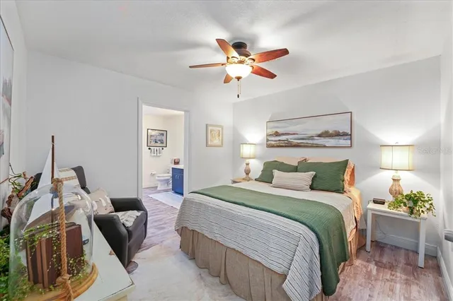 a bedroom with a bed and ceiling fan