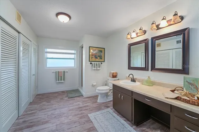 a bathroom with a sink a toilet and mirror